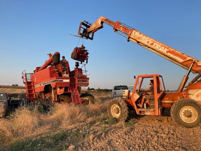 Obed uses a Sky Track to lower an engine into a combine