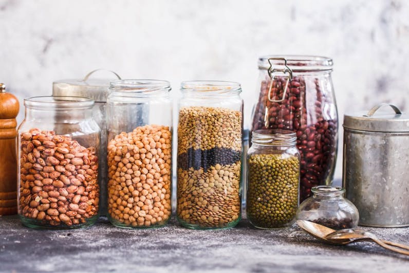 Different type of legumes in glass jars