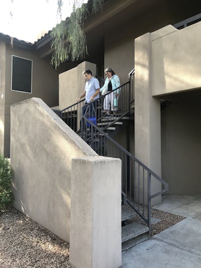 Doc and his wife on stairs leaving for treatment