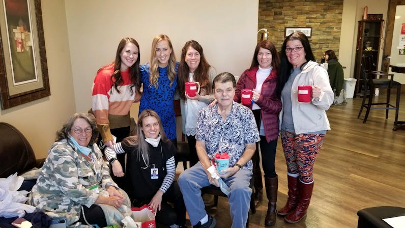 Doc sitting in Envita lobby with staff and family